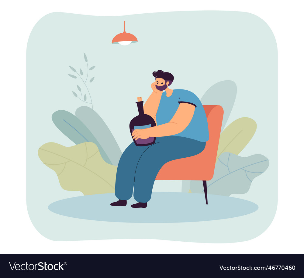 Depressed man sitting on chair with alcohol bottle