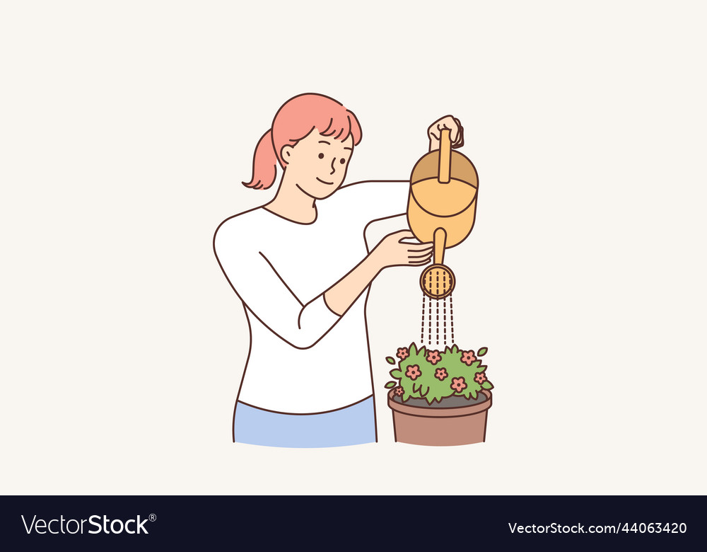 Smiling woman watering houseplant