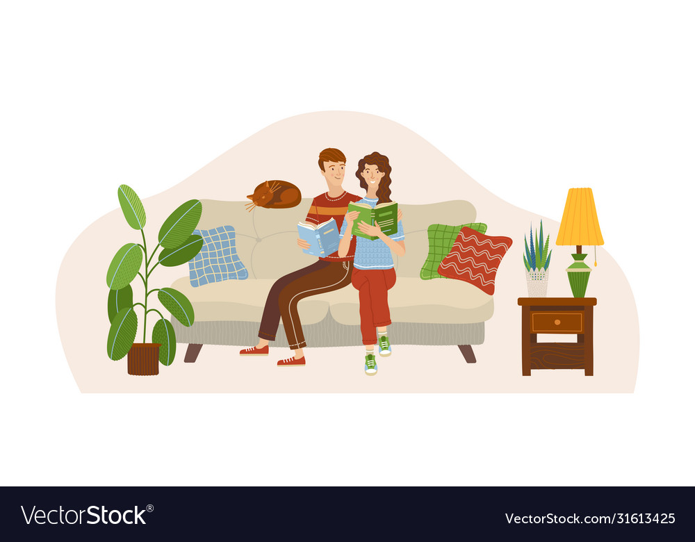 Couple in love reading books on sofa