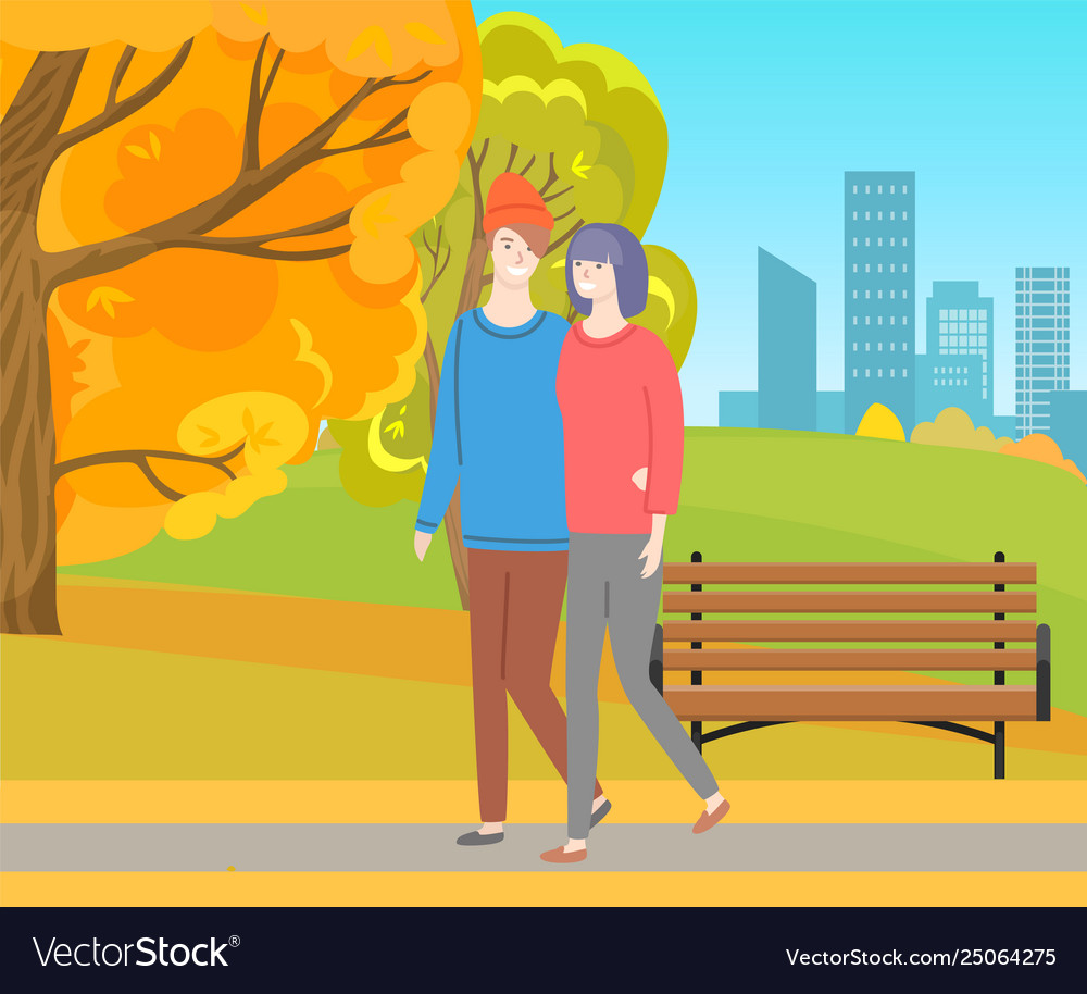 Man and woman walking together in autumn park