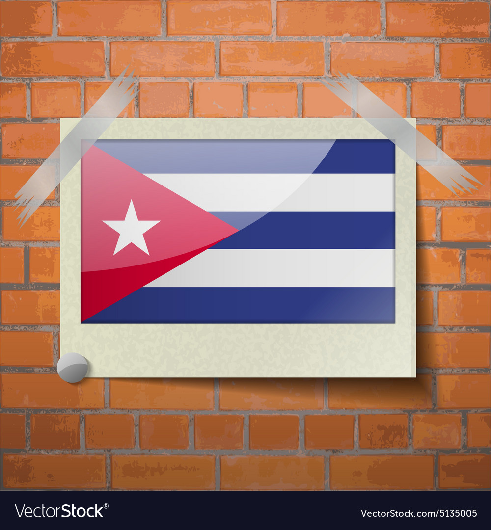 Flags cuba scotch taped to a red brick wall