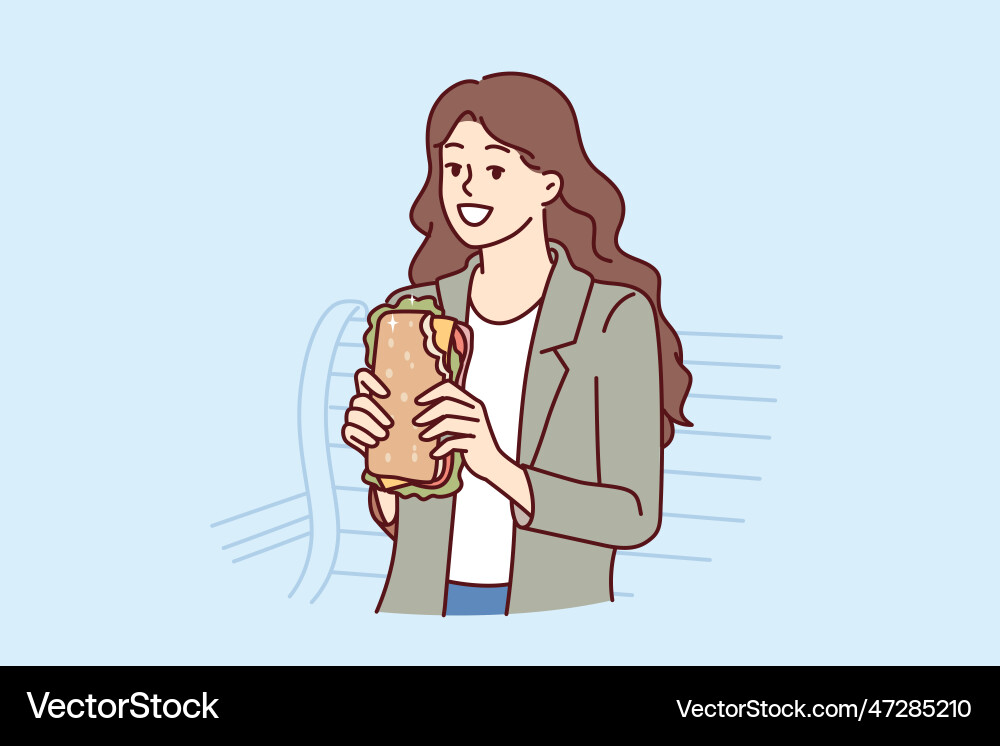 Woman eats sandwich while sitting on bench in park