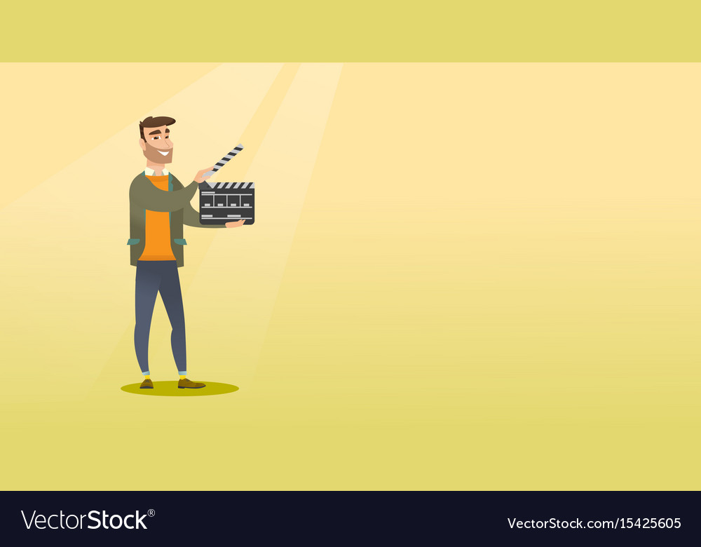 Smiling man holding an open clapperboard