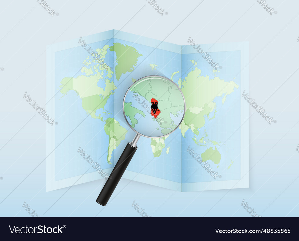 A folded world map with magnifying lens