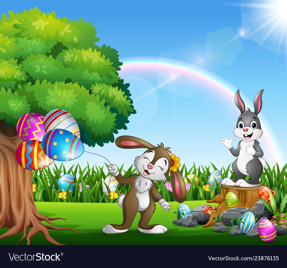 Easter bunnies and colorful egg on the garden