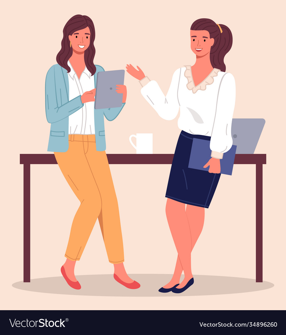 Two Women Chatting at Office Table
