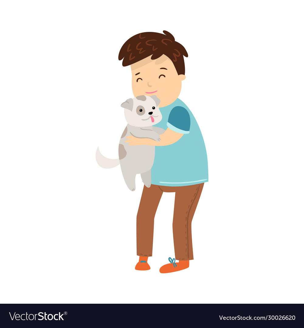 Boy standing and holding his puppy dog pet