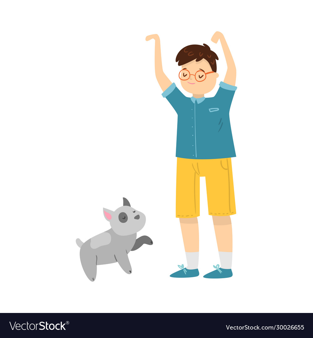 Boy standing and training his puppy dog pet