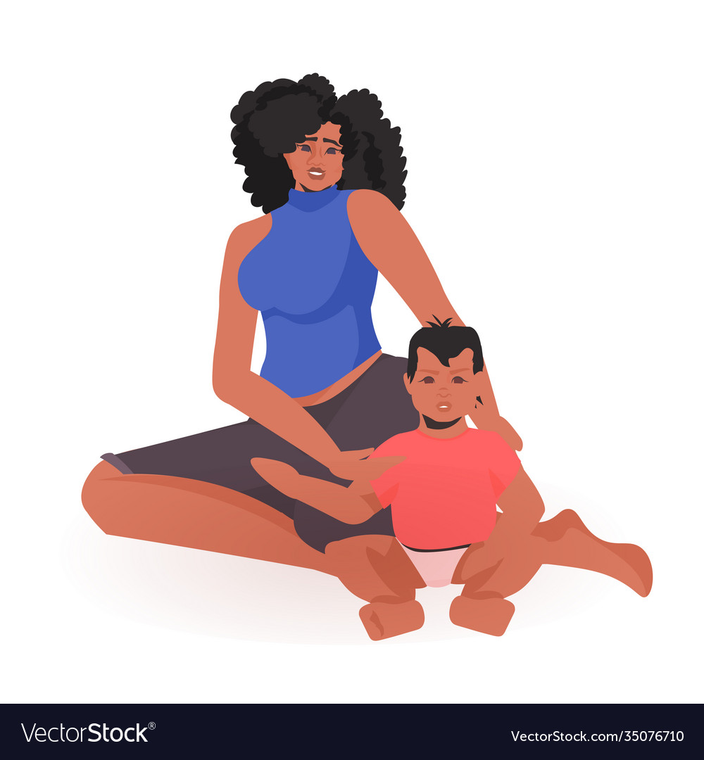 Young african american mother playing with newborn