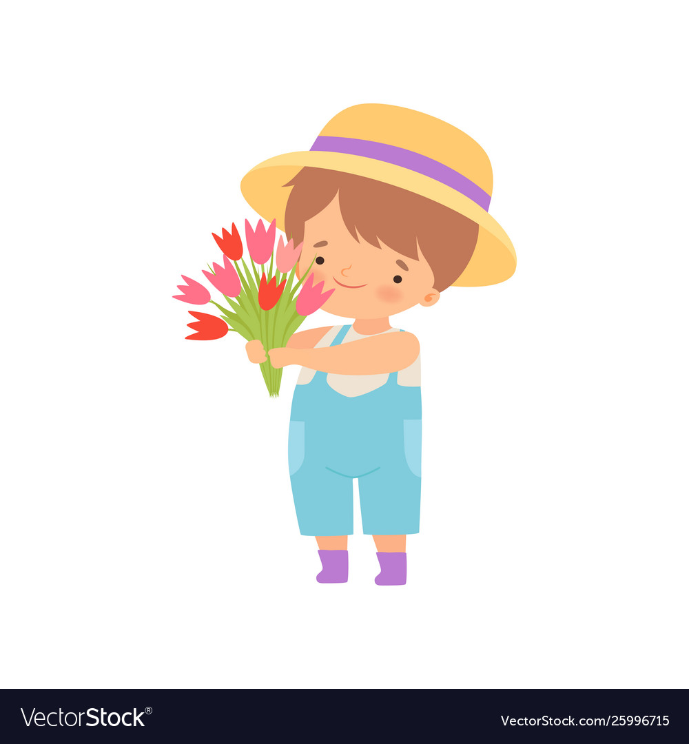 Adorable little boy in hat standing with bouquet