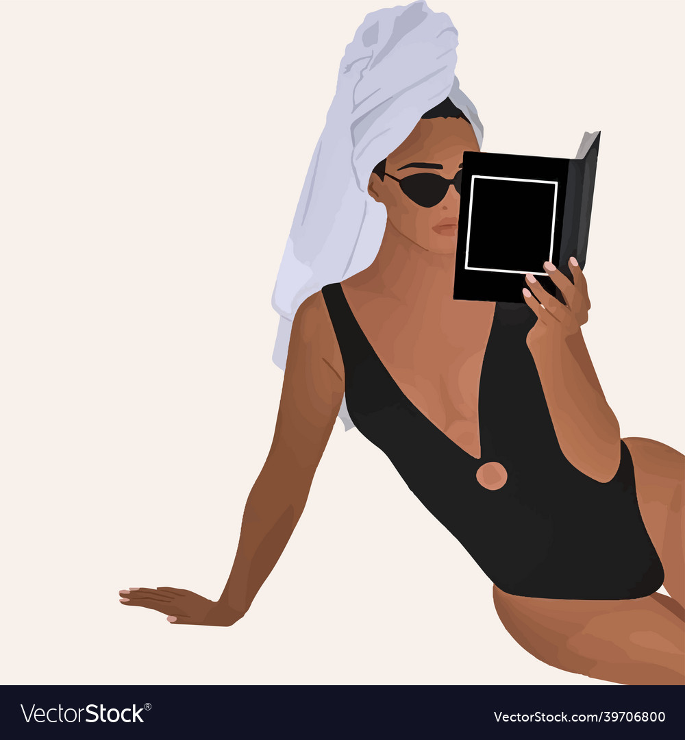 Elegant woman in towel and glasses reads a book