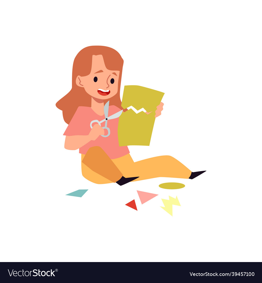 Cute kid girl sitting in floor and cut color paper