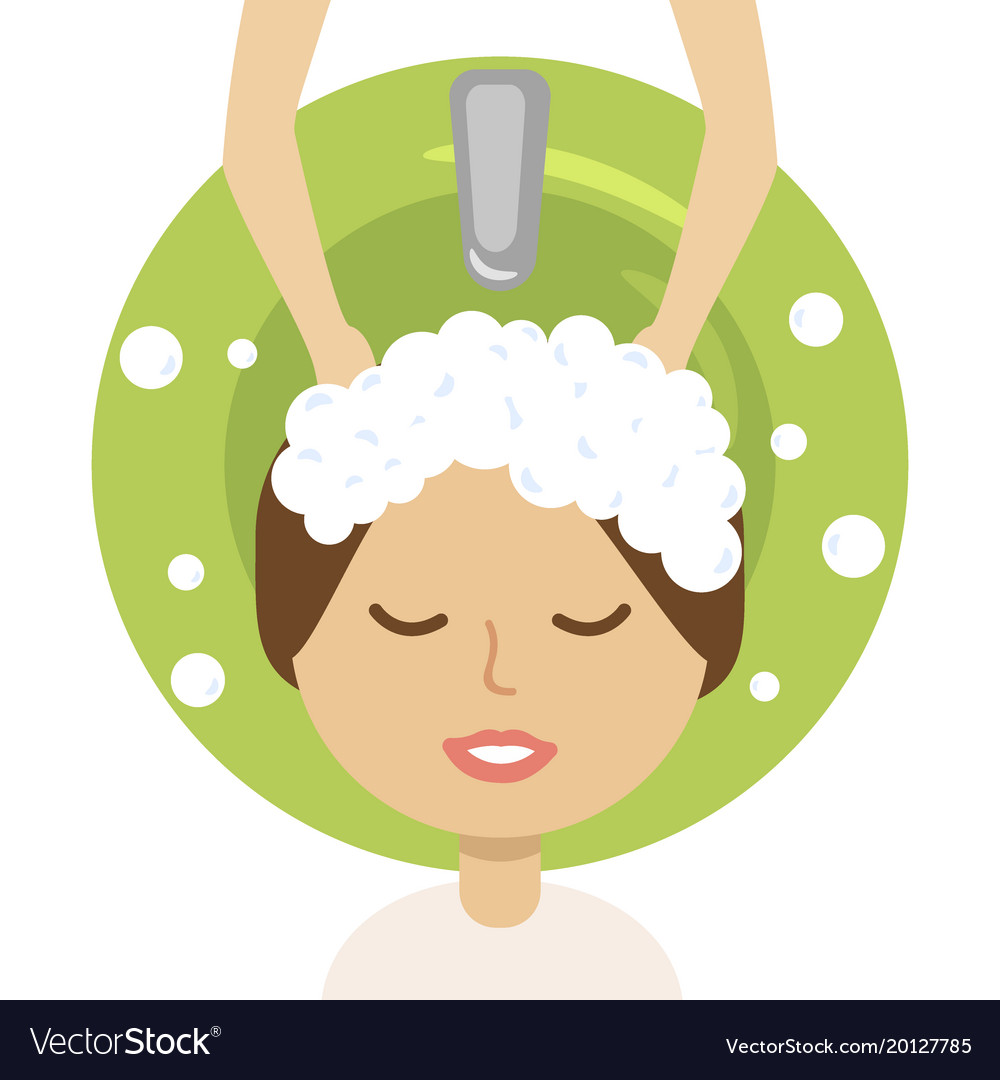 Young woman and hairdresser washing her head