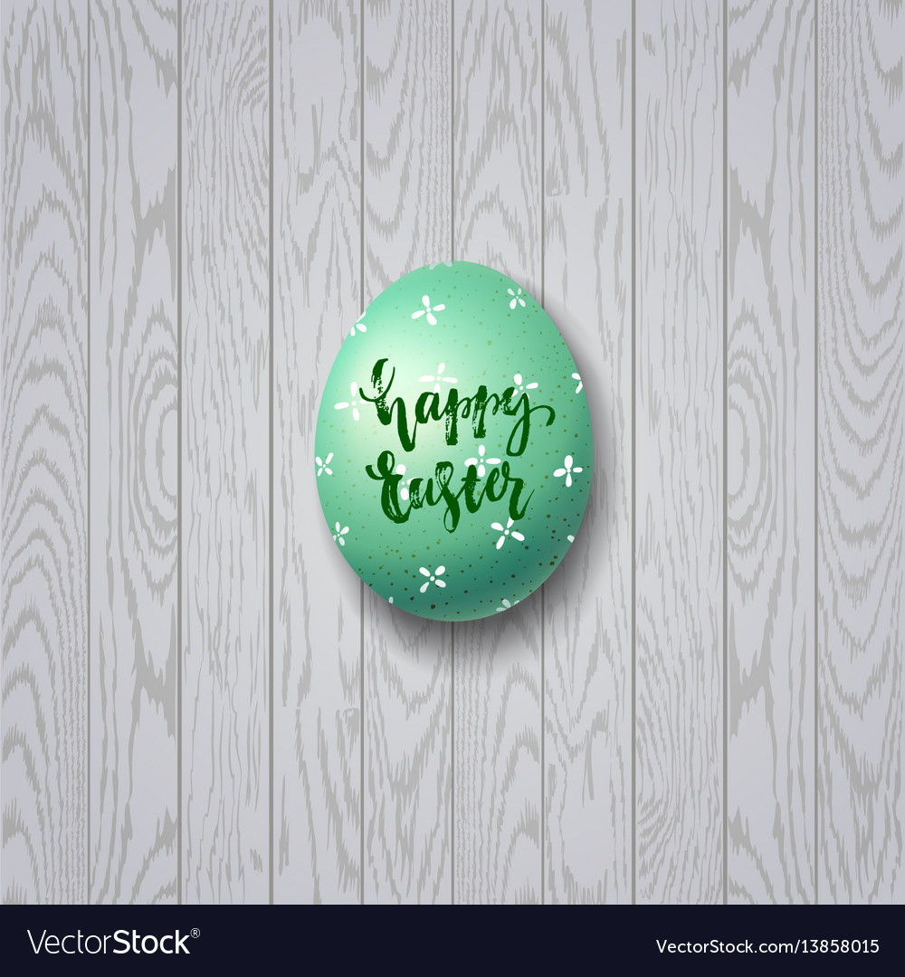 Colorful easter egg on white wooden background