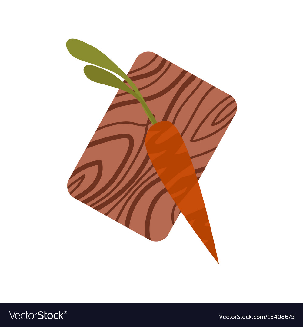 Dark orange carrot with tops on chopping board