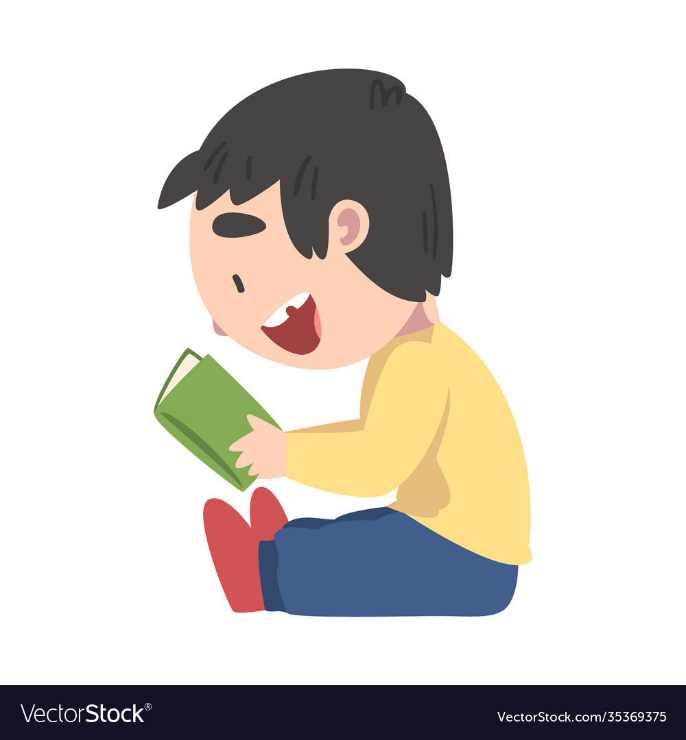 Happy smiling boy sitting on floor and reading