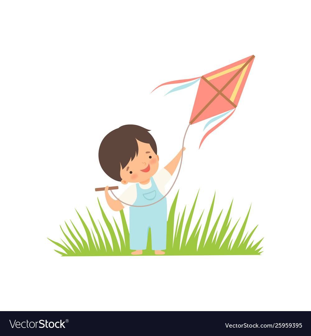 Cute happy boy enjoying flying kite on green