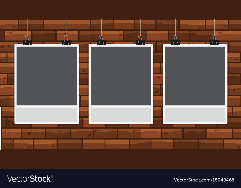 Three pictureframes on brickwall