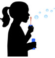 little girl blowing soap bubbles silhouette vector image