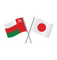 oman and japan crossed flags vector image