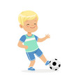 boy playing soccer kid kicking a ball colorful vector image