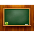 blackboard with green apple on wooden background vector image