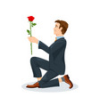man is kneeling with a flower in his hand view vector image vector image