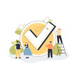 tiny people standing near big checkmark vector image