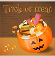 jack-o-lantern candy basket with pile colorful vector image vector image