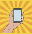 hand holds a mobile phone pop art comic style vector image