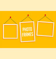 hanging photo frames on yellow background vector image vector image