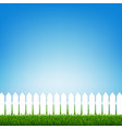 white fence with green grass and blue sky vector image vector image